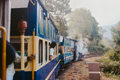 Blue and Yellow Train on Rail Tracks