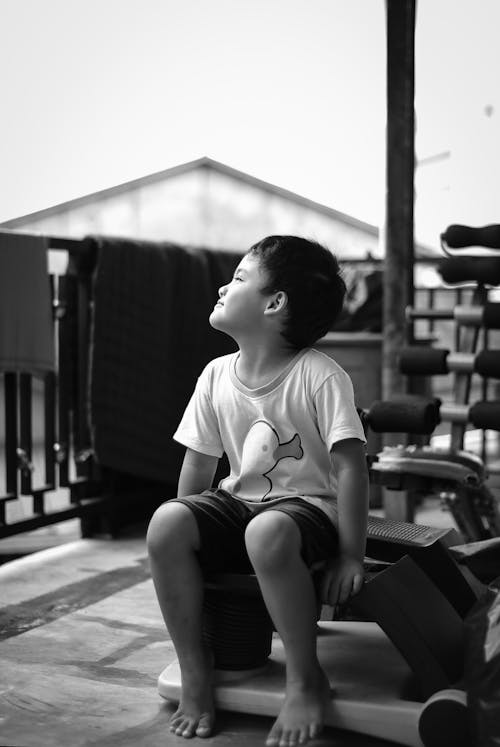 Boy in White Crew Neck T-shirt Sitting 