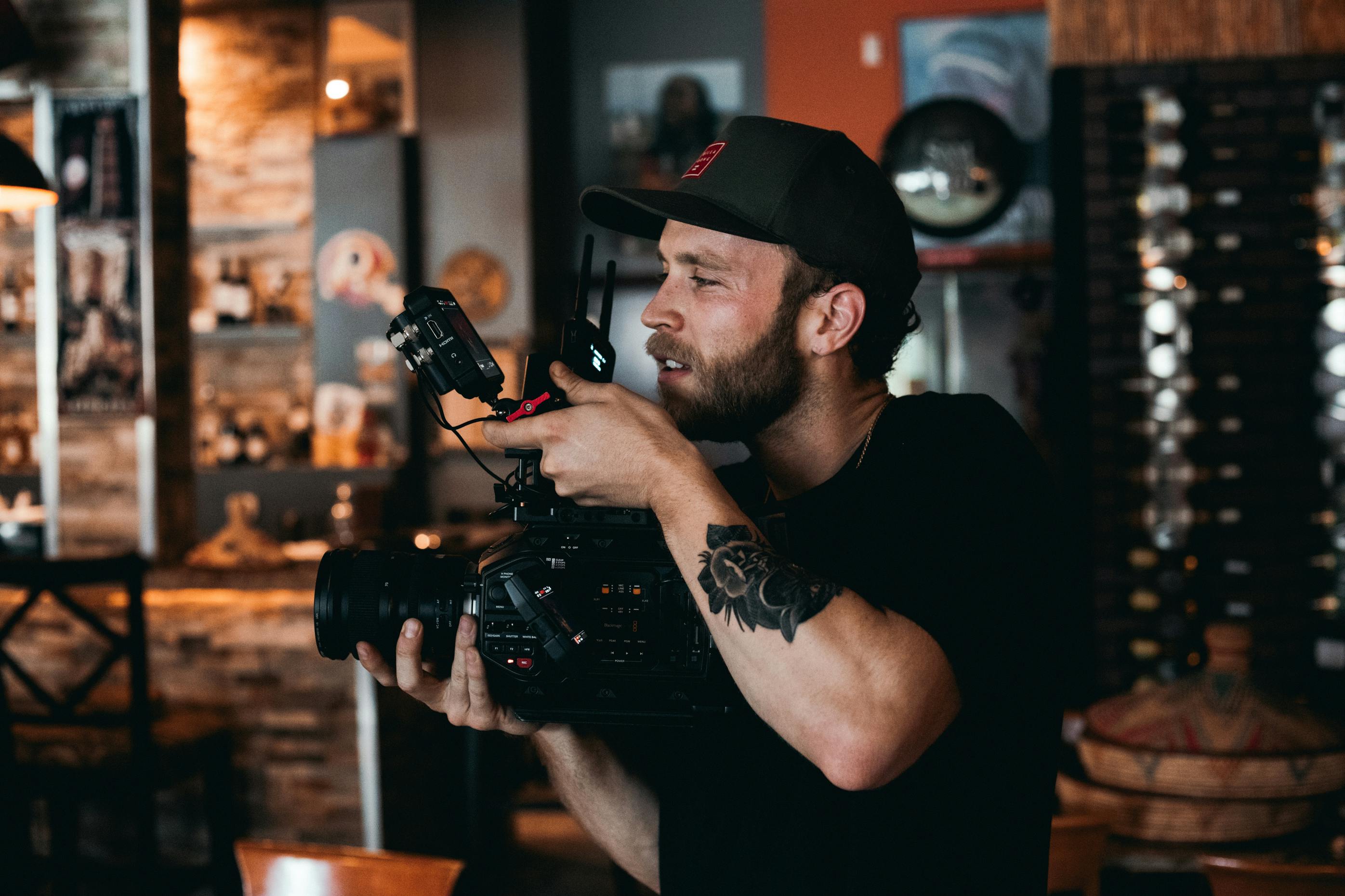 a bearded man shooting a film