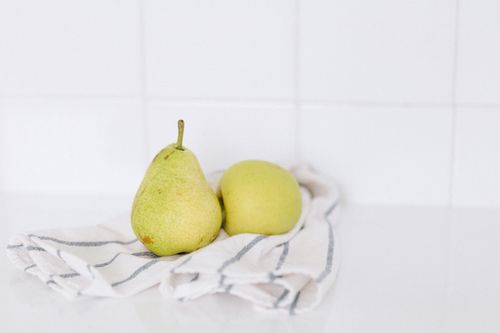 Free A fresh pear and apple on a striped cloth, perfect for healthy eating concepts. Stock Photo