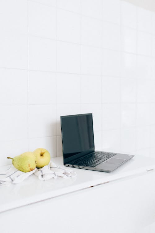 Pears Beside a Laptop