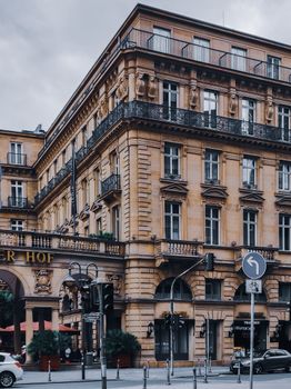 Exterior of hotel in aged building placed near asphalt road located in Frankfurt in Germany