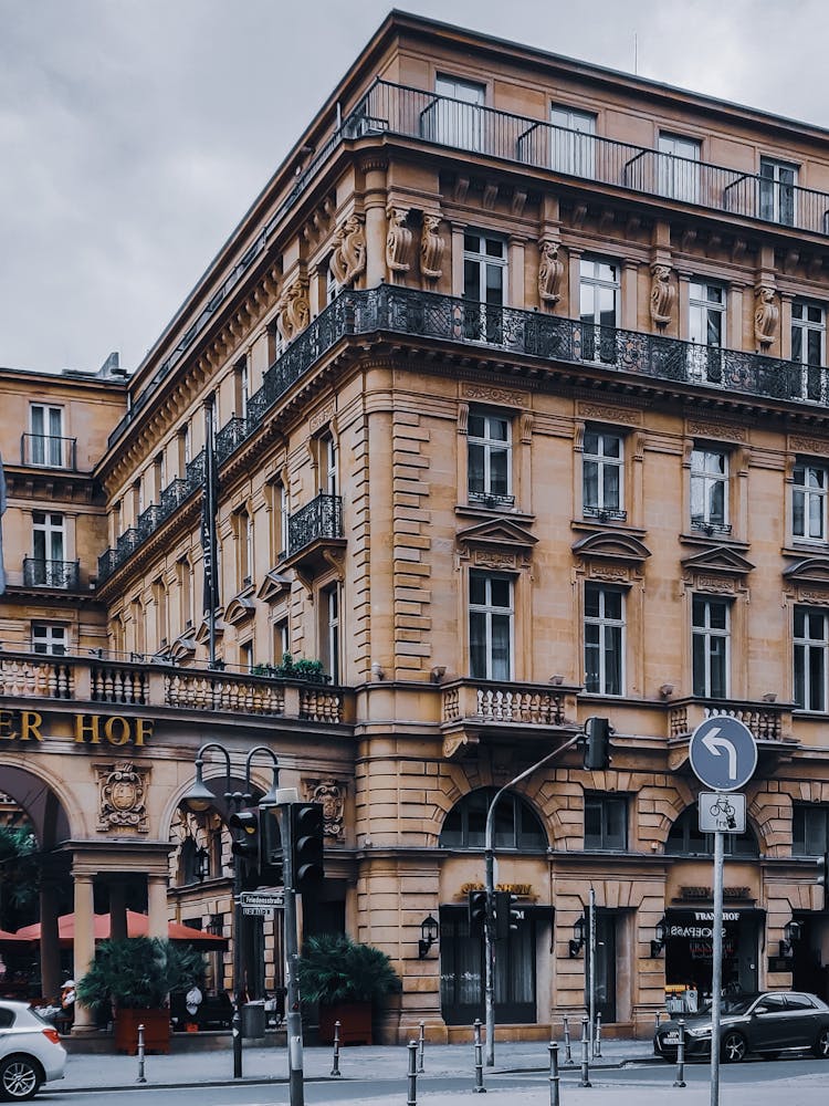 Facade Of Hotel In Old Building With Ornamental Walls