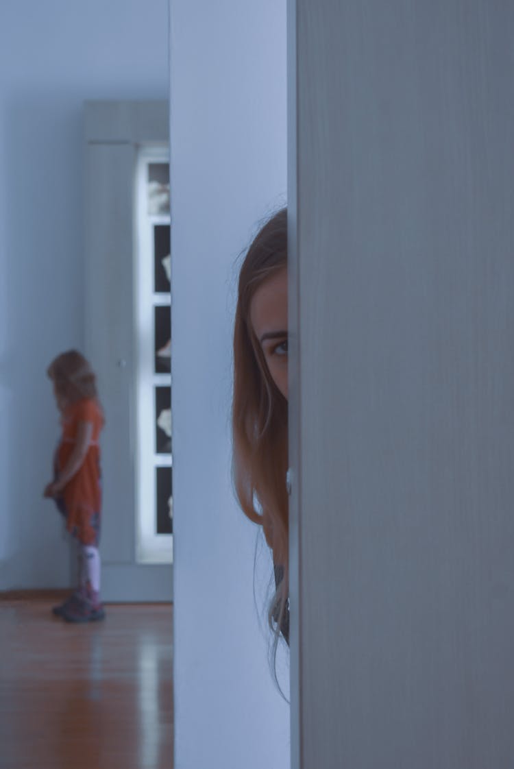 Young Woman Peeping And Looking At Child