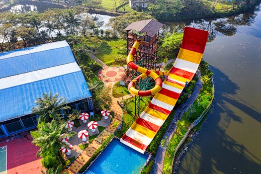 A vibrant aerial photo of a colorful water slide at a theme park in Banten, Indonesia, by a serene river.