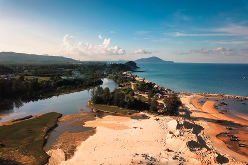 Free Aerial view of picturesque landscape of blue ocean water near coastline with boats and green tropical forest Stock Photo
