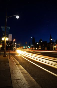 Dynamic long exposure of street lights at night in Ottawa, showcasing city life and movement.