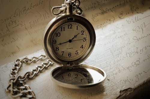 Free Close-Up Shot of a Silver Pocket Watch Stock Photo
