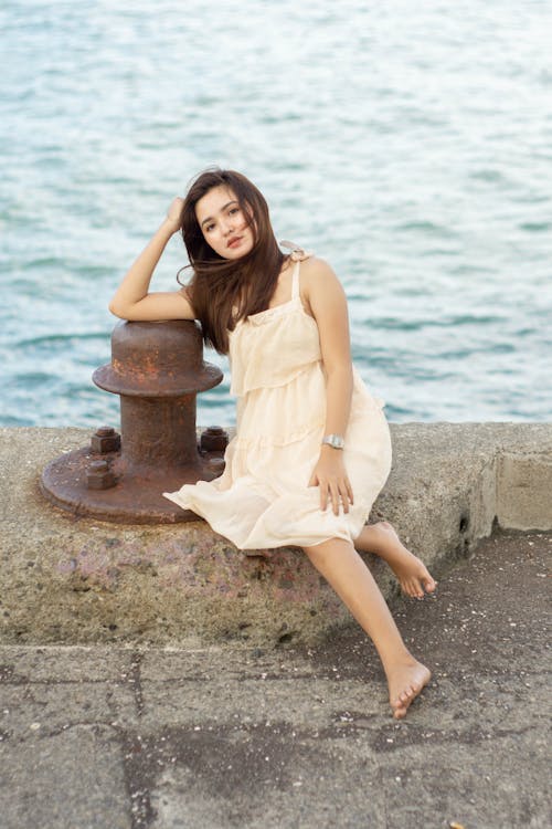 Young relaxed female resting on sea embankment