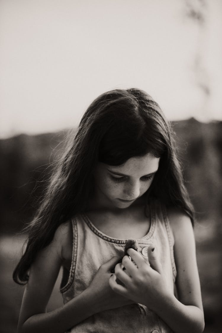 Grayscale Photo Of A Girl Holding A Chick