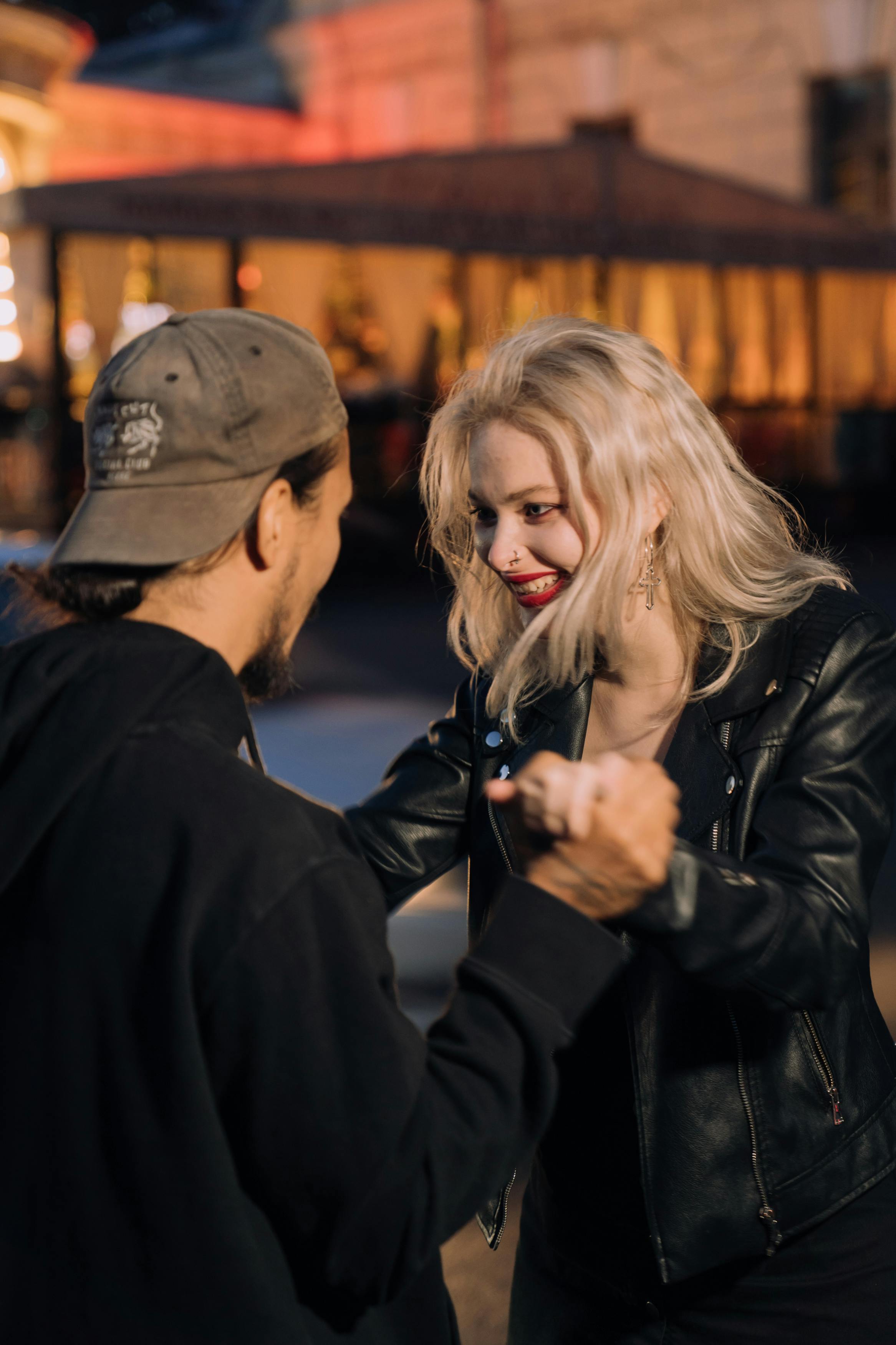 man holding the hand of a blond woman