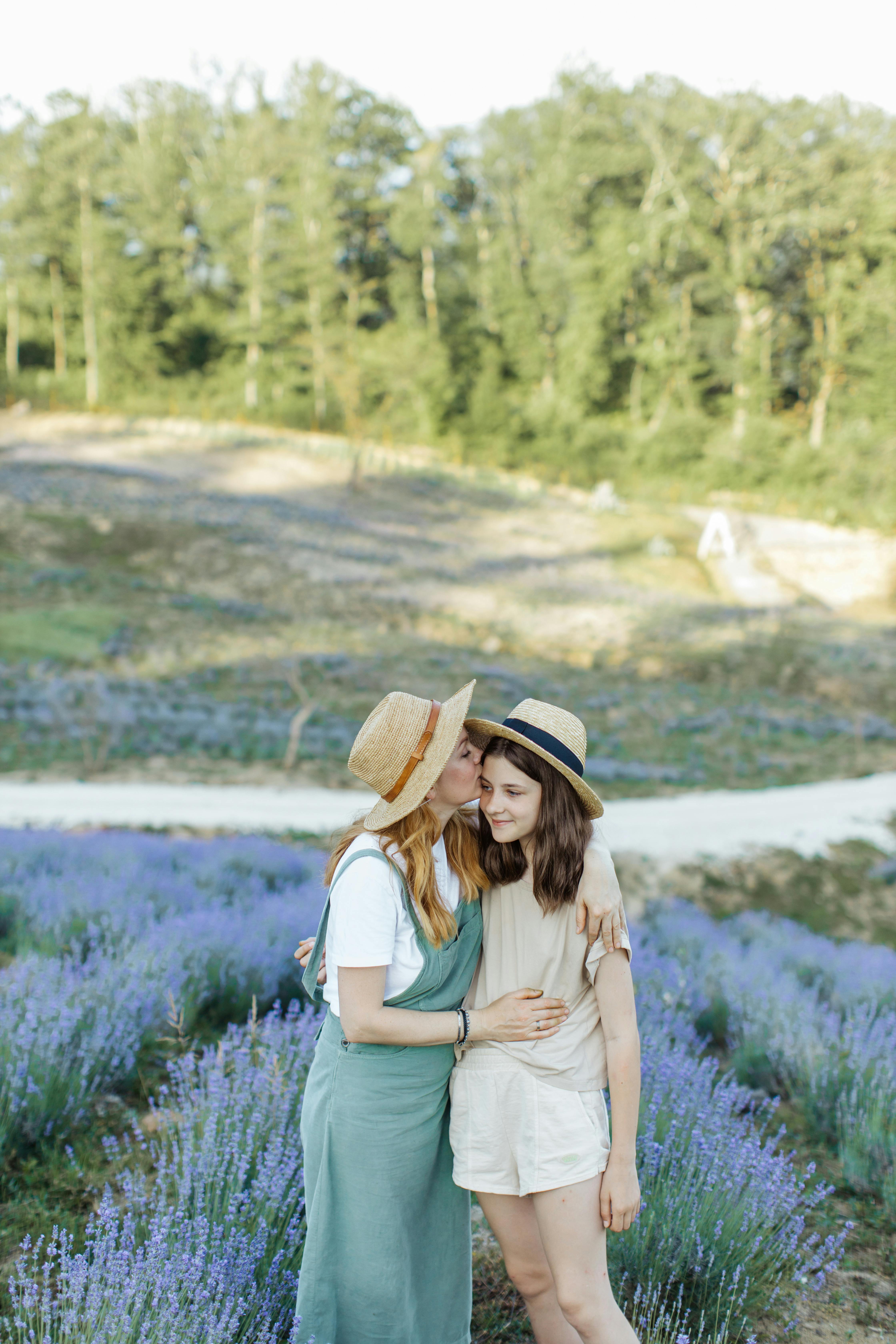 Free A heartwarming moment of mother and daughter bonding in a lavender field. Stock Photo