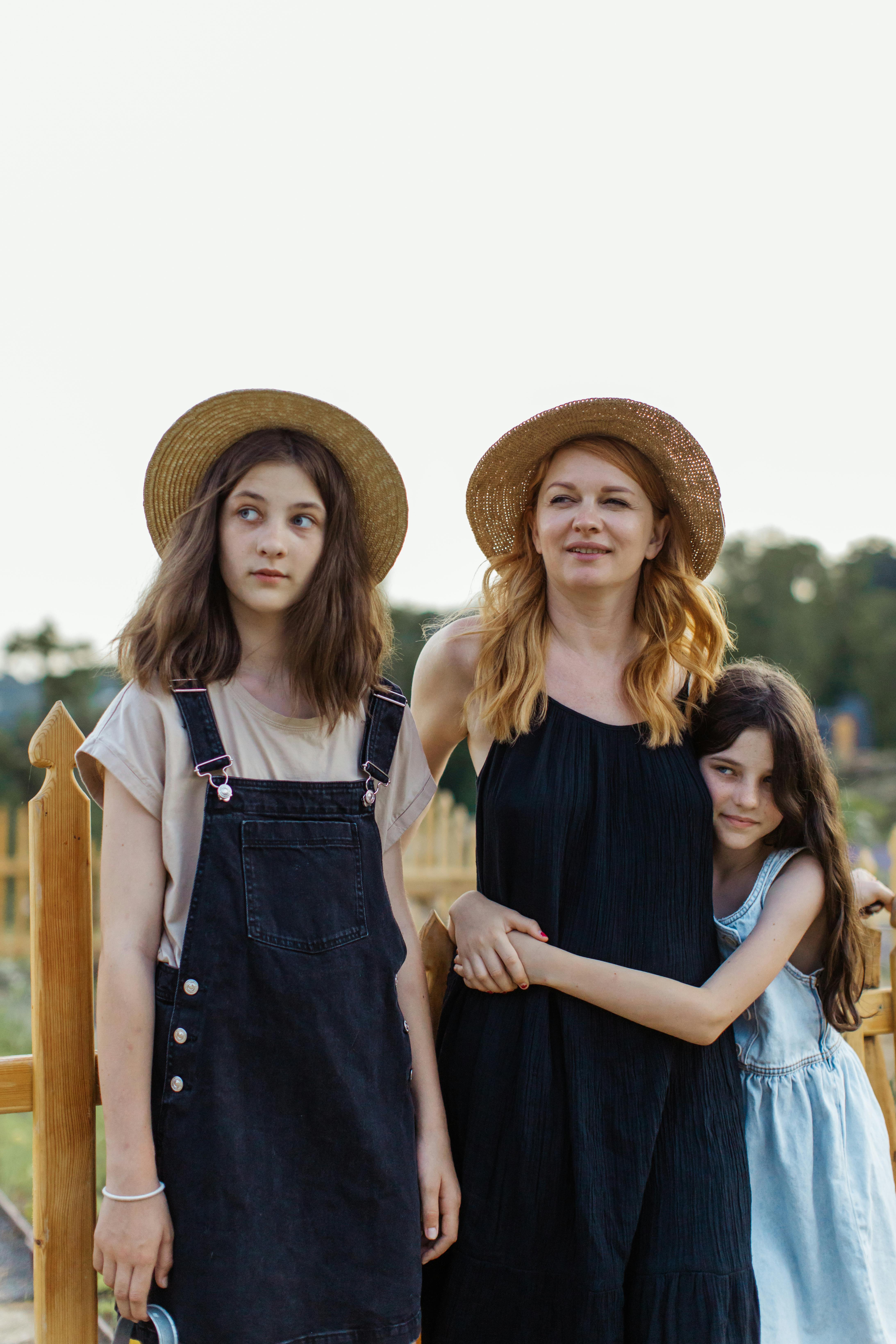 a mother standing together with her daughters