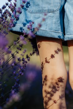 Denim shorts lend a casual vibe as lavender casts shadows on sunlit skin.