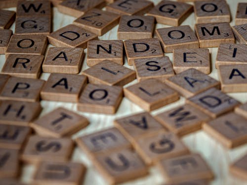 A Close-up Shot of a Wooden Scrabble Tiles