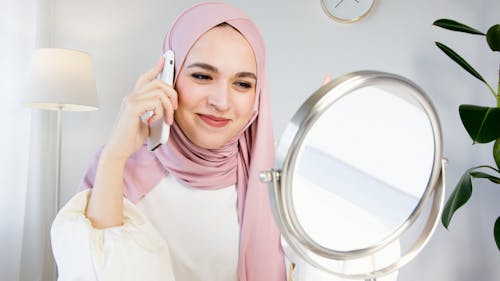Woman in Pink Hijab Holding White Smartphone