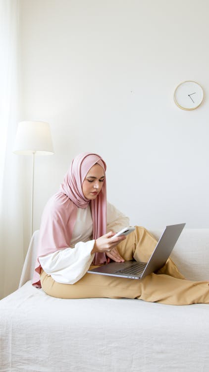 Woman in Pink Hijab Using Laptop Computer
