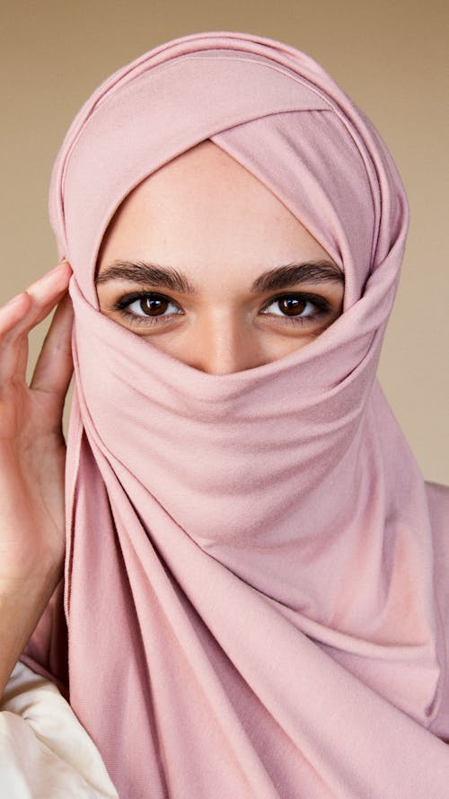 Free Woman in Pink Hijab Hiding Mouth Stock Photo