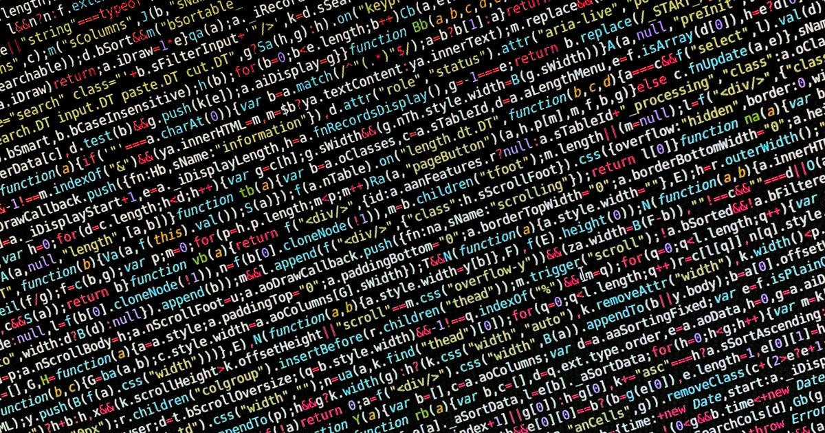 JavaScript vs TypeScript: Which Should You Actually Use in 2026? 2 Colorful lines of code on a dark monitor screen in a development environment