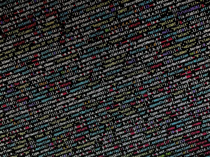 Colorful full-stack programming code on screen representing MERN stack development