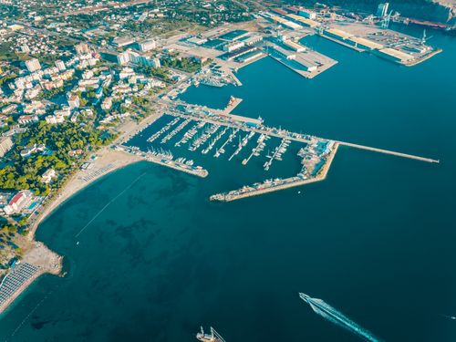Free Stunning aerial shot of Bar harbor in Montenegro, showcasing boats, clear waters, and cityscape. Stock Photo