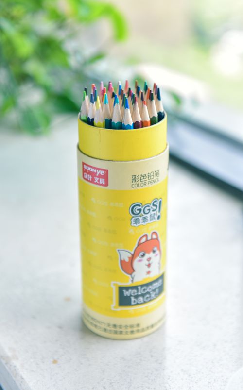 Free Bright yellow case with colorful pencils standing on a table, perfect for creativity and arts. Stock Photo