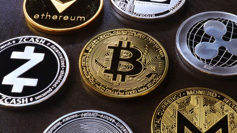 Detailed view of assorted cryptocurrency coins including Bitcoin, Ethereum, and Ripple.