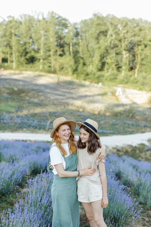 Mother and Daughter Standing on the Flower Field