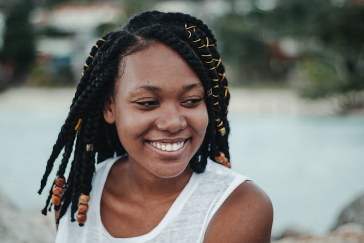 Stylish Dreamy Black Woman Near Pond In Daylight