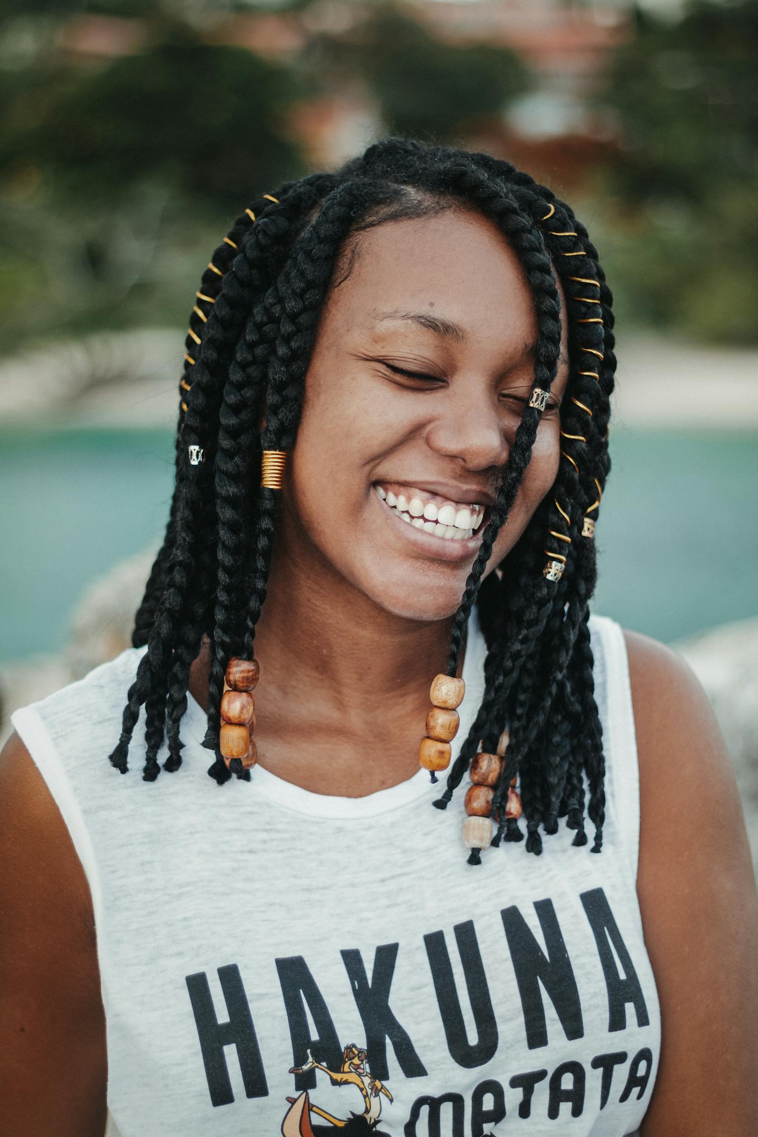 Cheerful black woman with closed eyes behind lake · Free Stock Photo