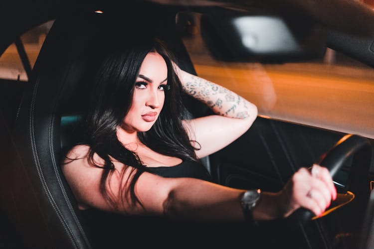 Beautiful Woman Driving Car At Night