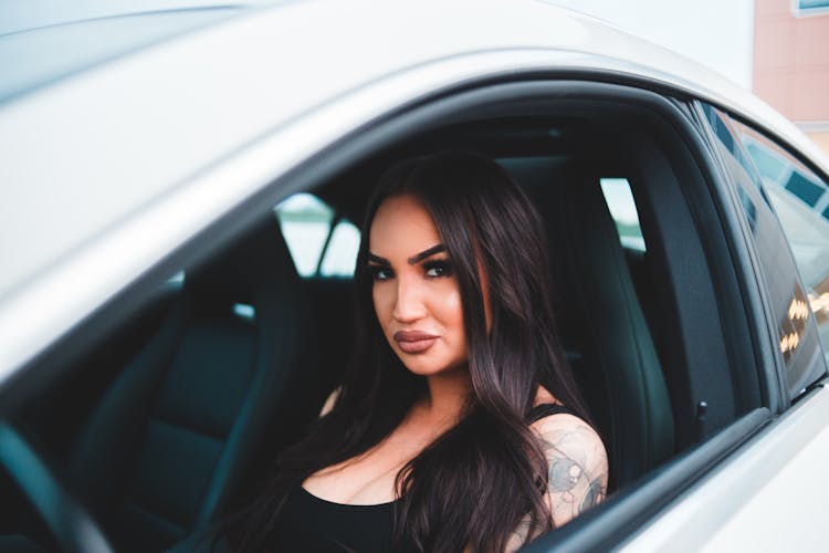 Confident Woman In Cabin Of Car