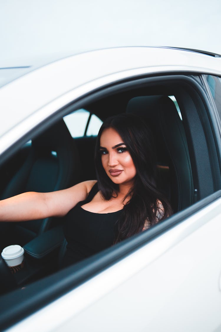 Charming Woman With Bright Makeup Driving Car In Daytime