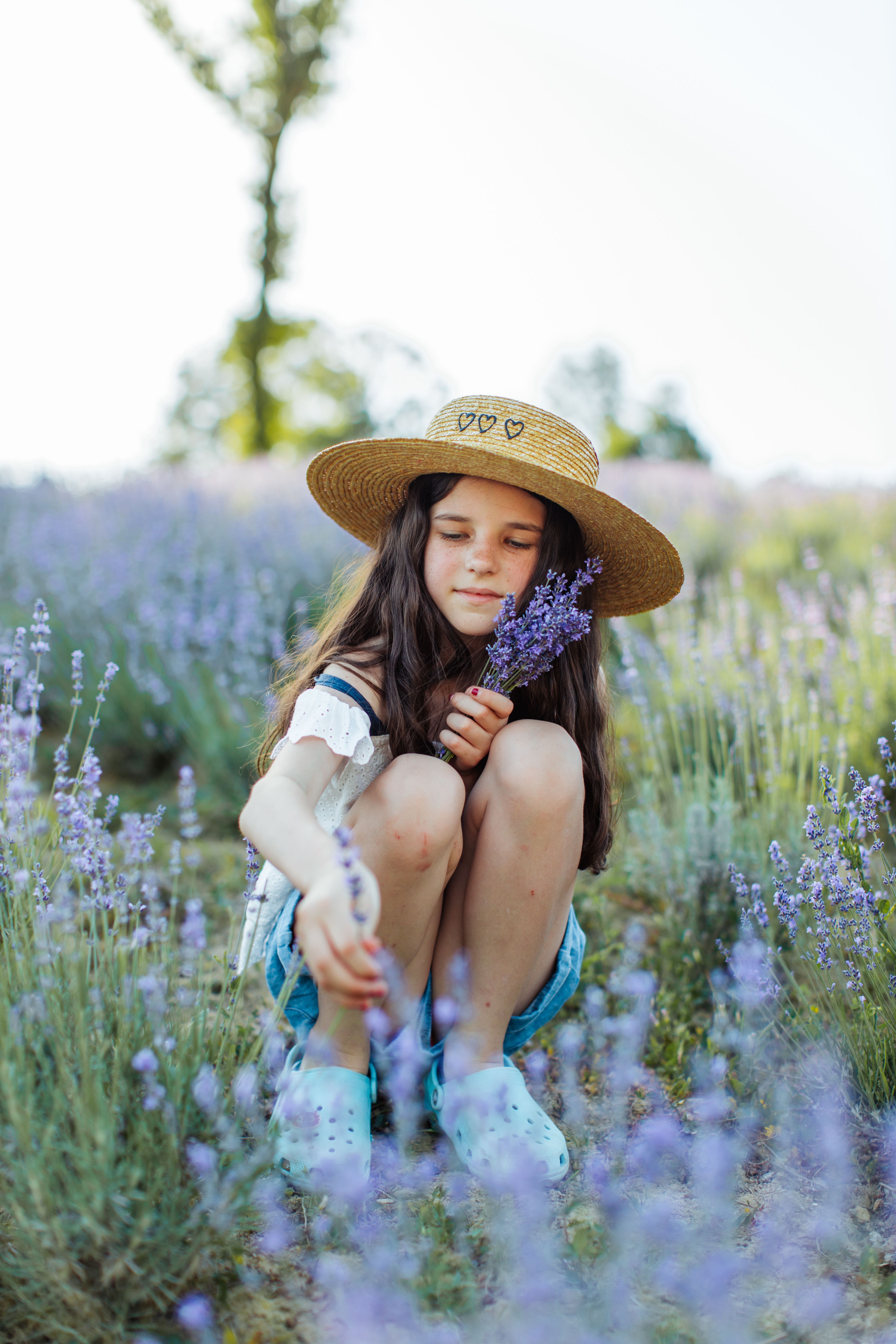 White Blouse Sitting on a Flower Field 