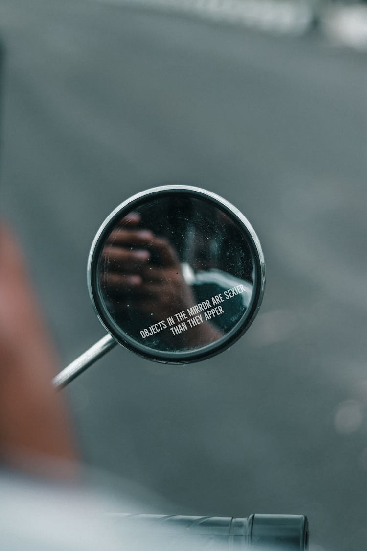 Man Driving Motorcycle And Taking Selfie In Rearview Mirror