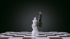 Clear Glass Human Figurine on White and Black Checkered Textile