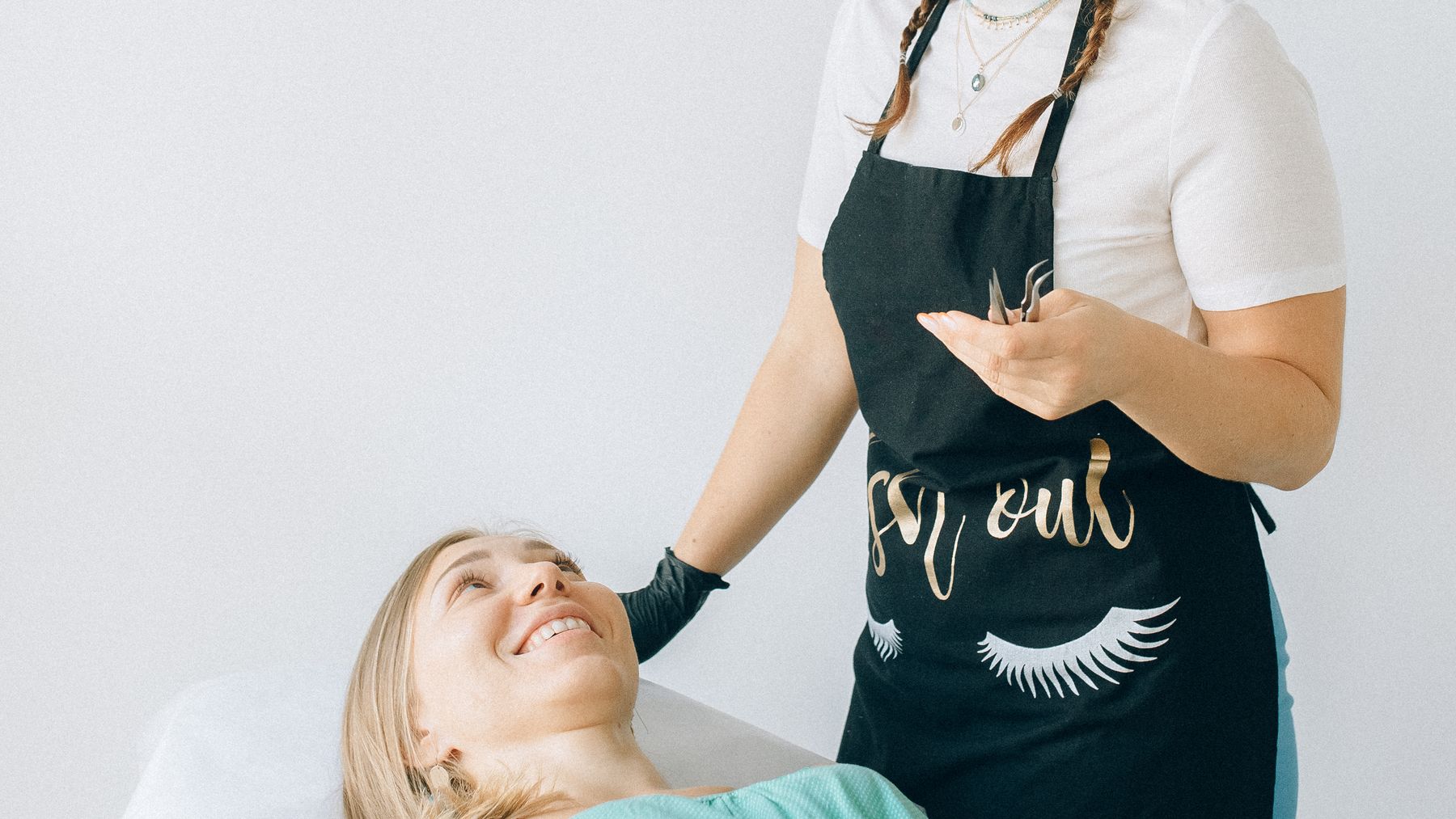 Smiling aesthetics professional speaking with a client in a bright treatment room