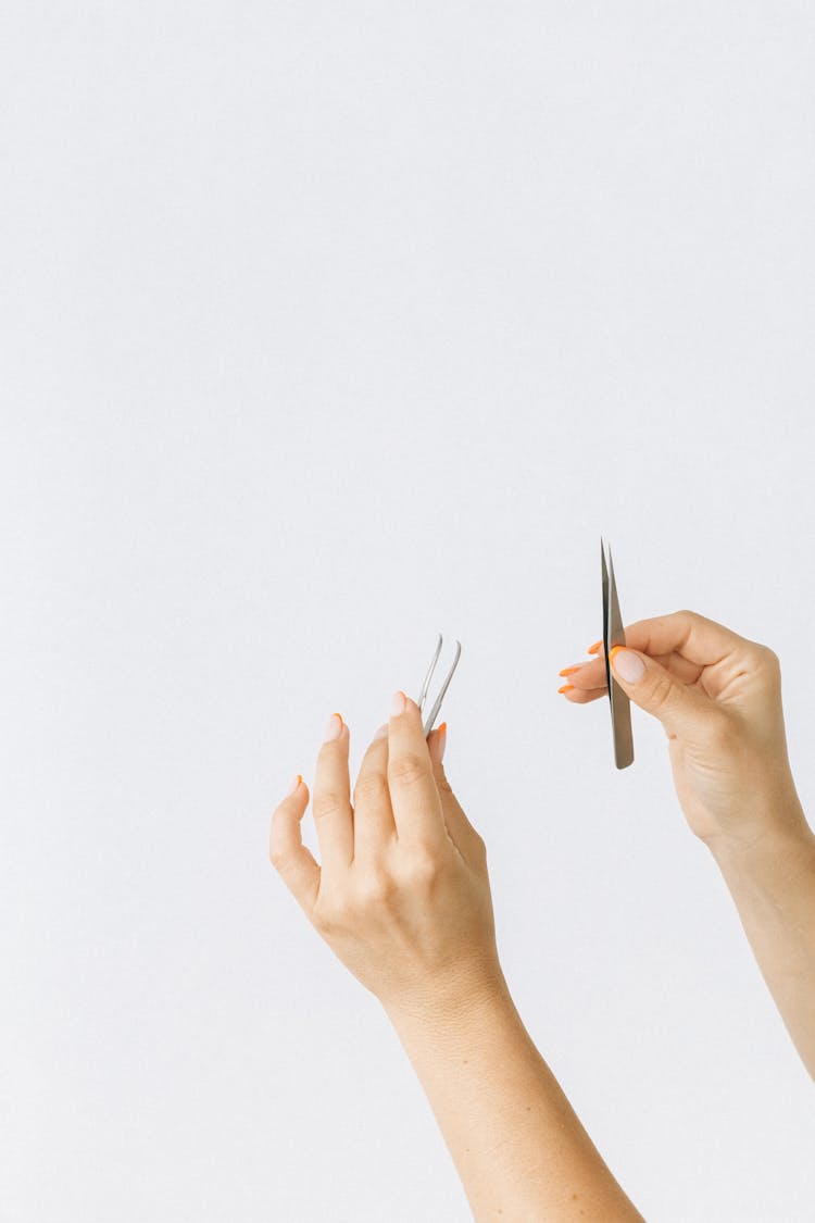 Person Holding Tweezers