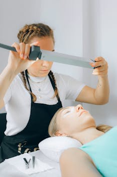 Beauty technician performing a cosmetic treatment in a spa setting, promoting relaxation and wellness.