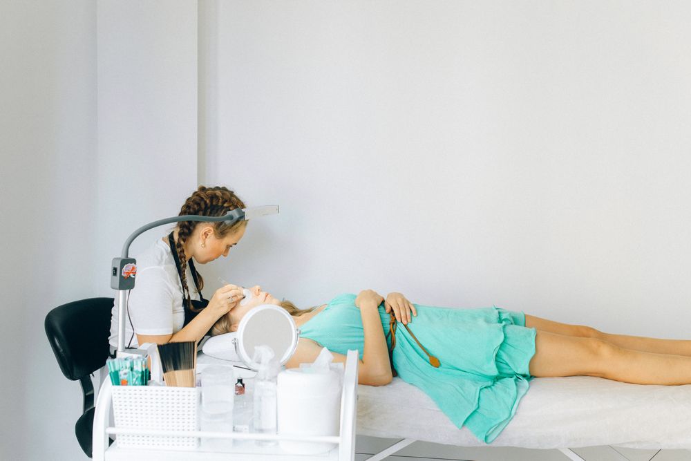Beauty artist working on a client in a modern studio