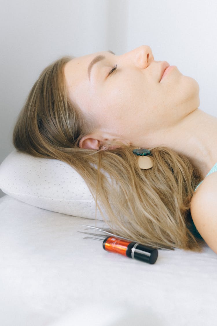 Woman Lying On White Bed