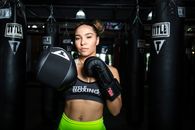 Boxer Standing Before Punching Bags