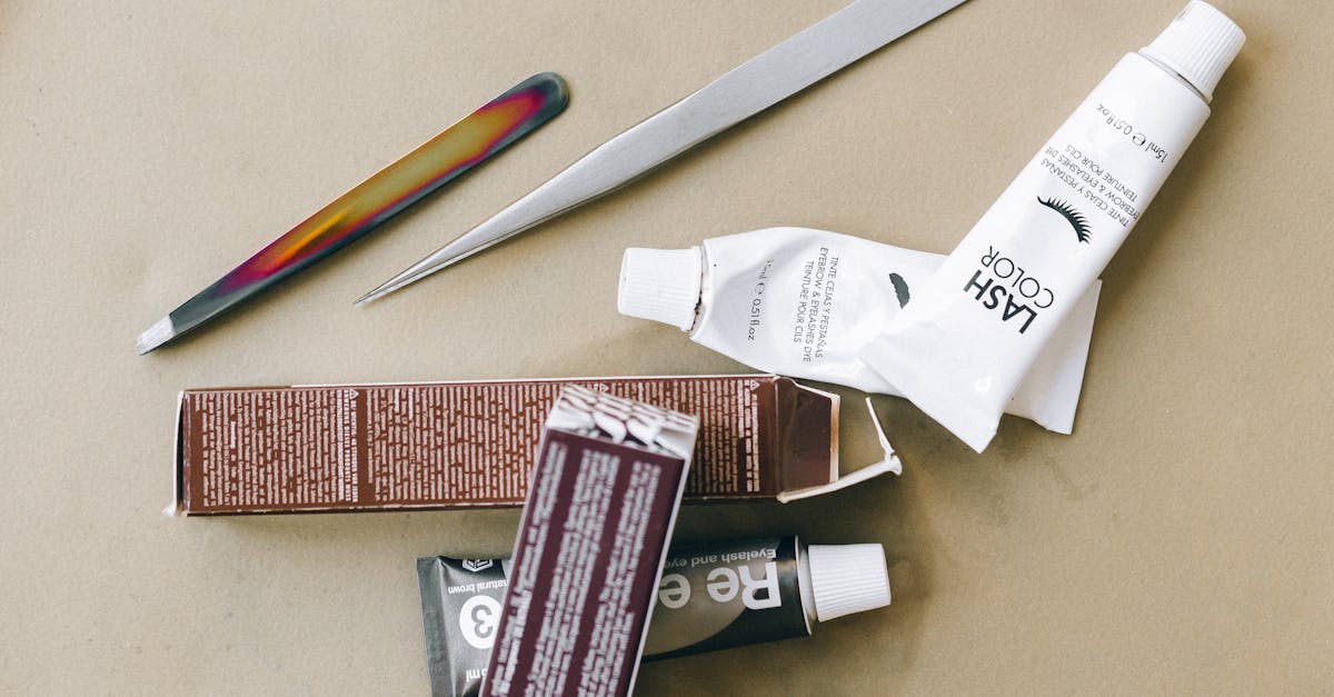 Flat lay of eyelash tint and beauty tools on a beige surface, ideal for salon promotions. Flat lay of eyelash tint and beauty tools on a beige surface, ideal for salon promotions.