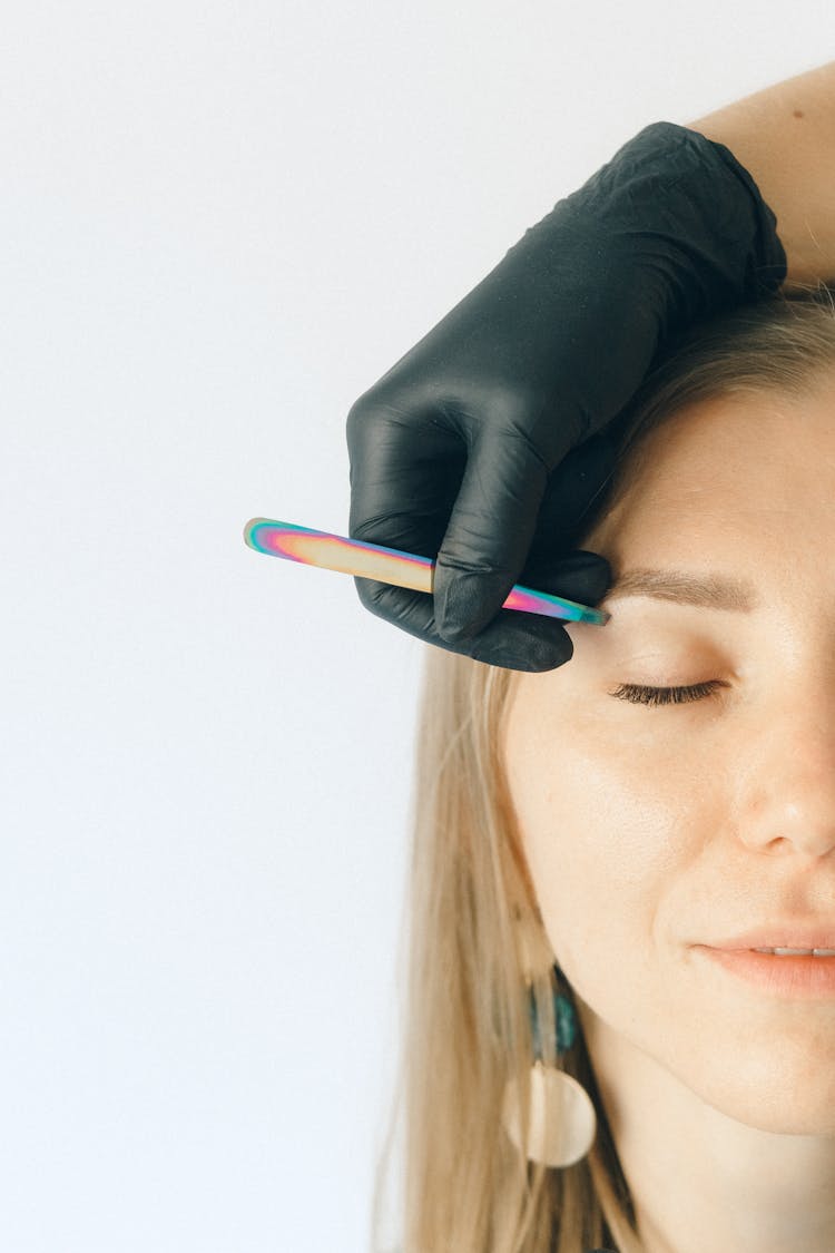 A Hand Plucking The Eyebrow Of A Client