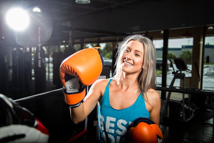 Happy Woman In Boxing Gloves Training