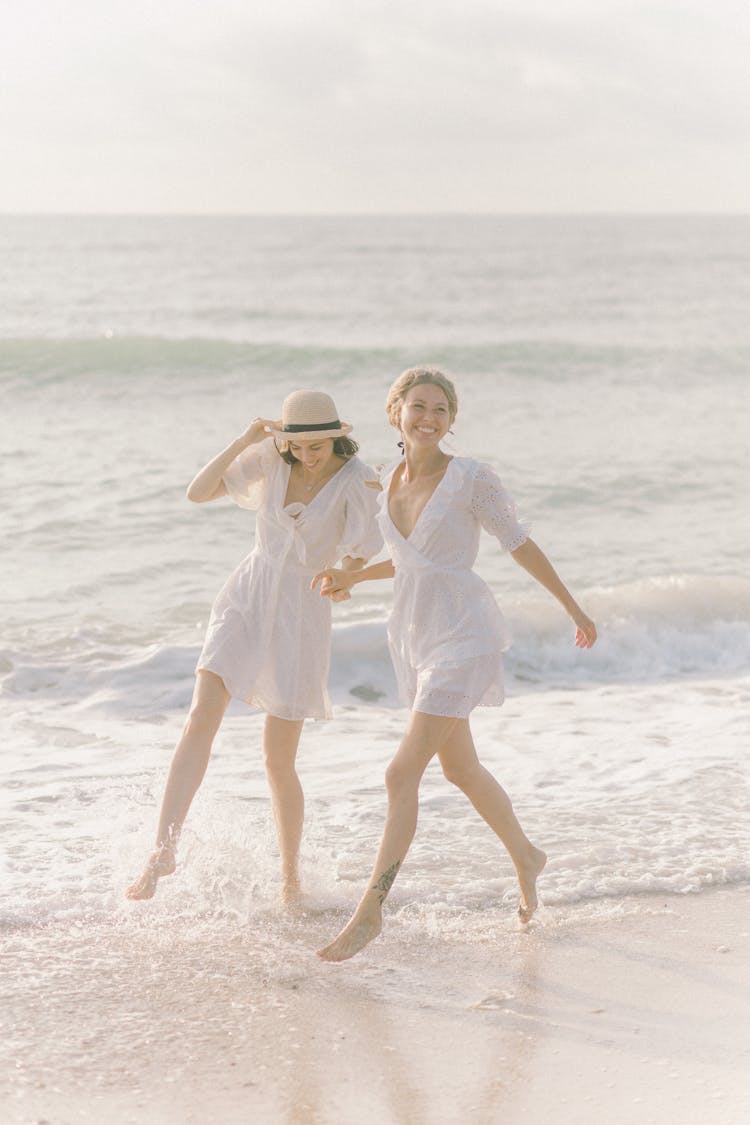 Couple Holding Hands While On The Beach