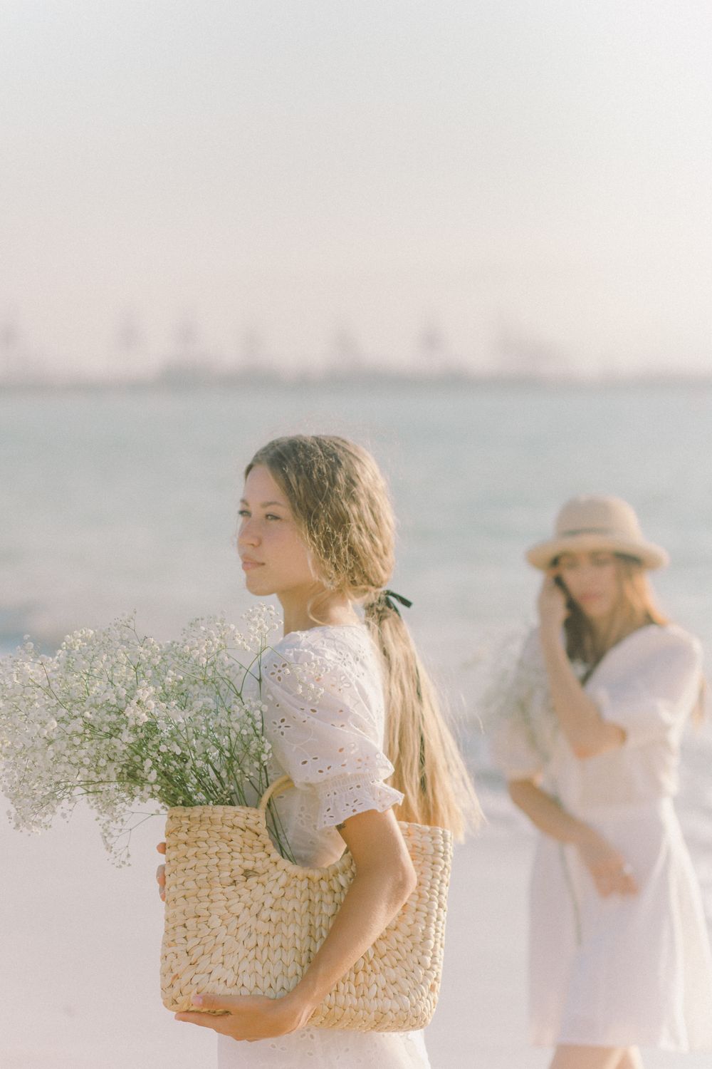 A Woman in White Dress Holding Basket of Flowers · Free Stock Photo
