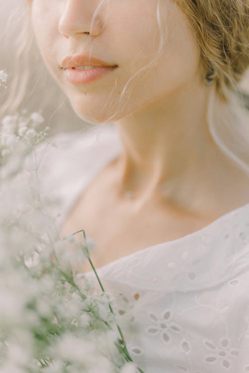 A Person in White Lace Blouse in Close-up Photography