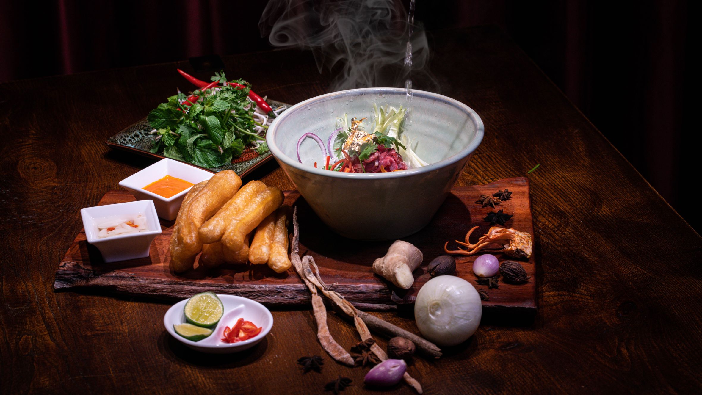 Savor the authentic taste of Vietnamese pho with fresh herbs, spices, and steaming broth in a cozy setting.