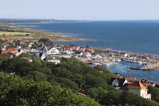 White and Brown Concrete Houses Near Body of Water